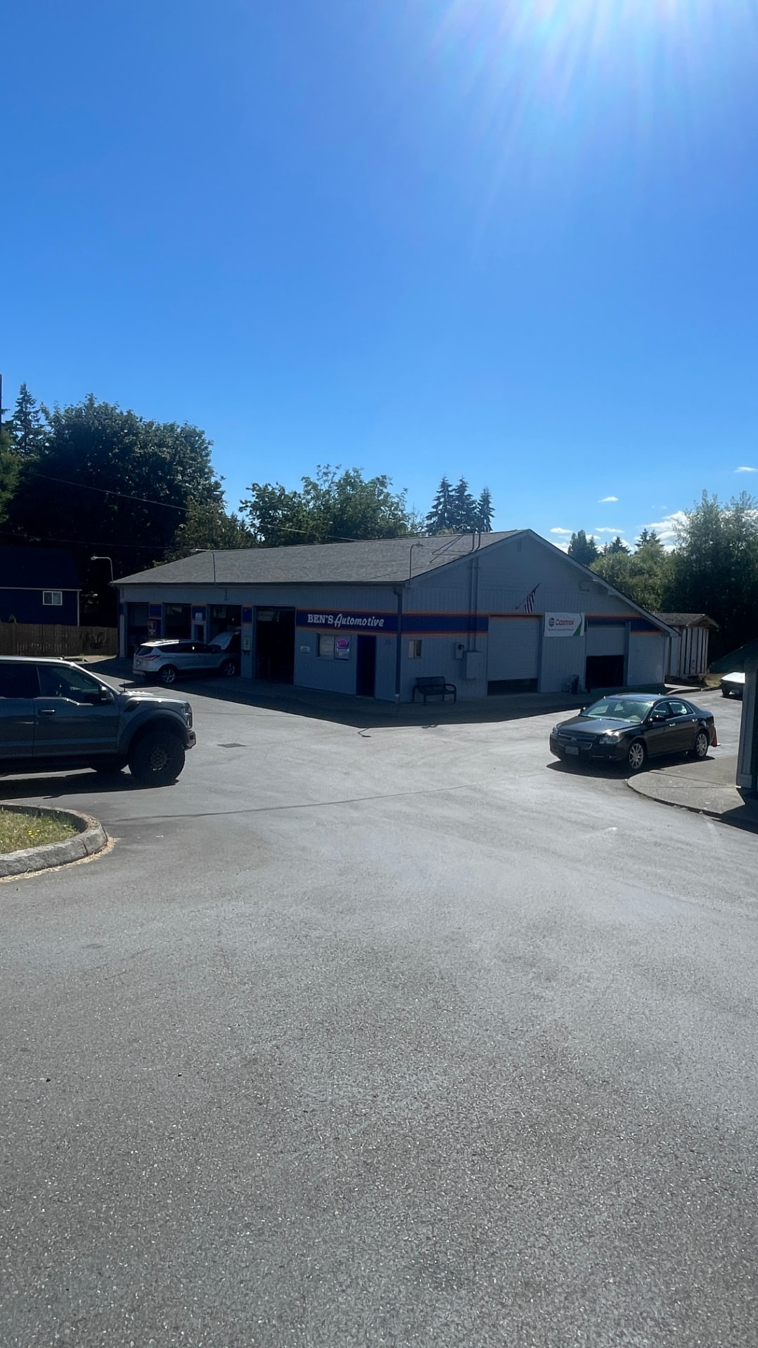 Ben's Automotive shop building and parking lot on a sunny day in Olympia, WA